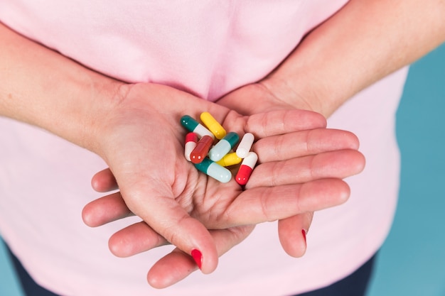 Close-up of a female hand holding capsule's in hand