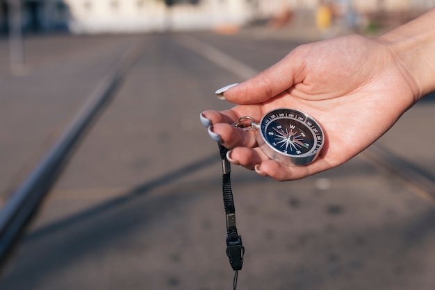 Close-up of female hand holding navigational compass