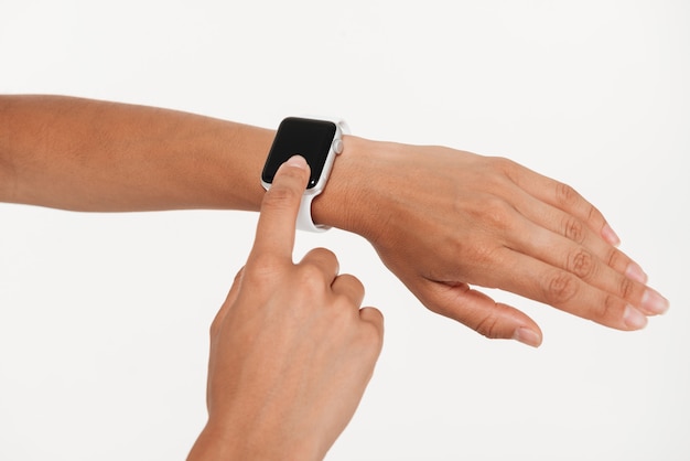 Free Photo close up of female hands using wrist smart watch