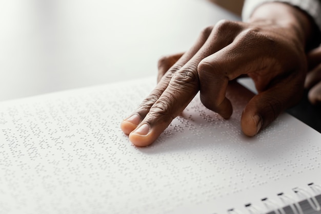 Close up fingers reading braille