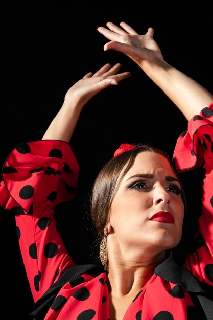 Close-up flamenca dancer raising hands 