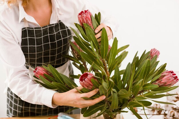 Close-up florist arranging a bouquet