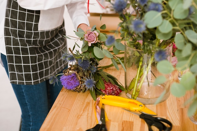 Close-up florist working in flower store