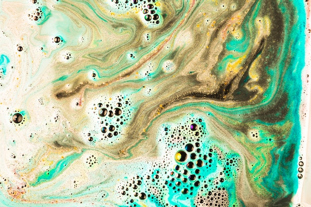 Free Photo close-up of foam after dissolving color bath bomb in water