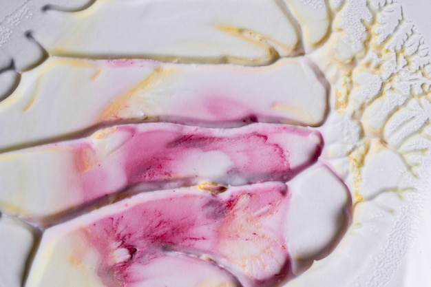 Free Photo close-up of foam surface with pink and yellow paint colors