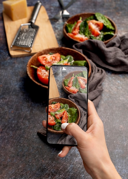 Free photo close up on food lover taking pictures of meal