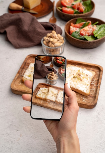 Free Photo close up on food lover taking pictures of meal