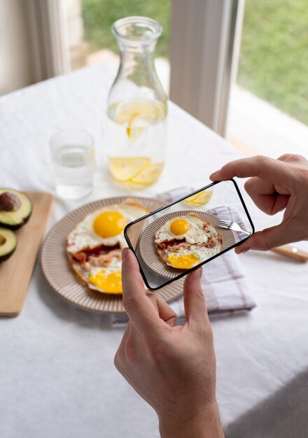 Close up on food lover taking pictures of meal