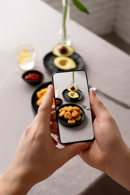 Close up on food lover taking pictures of meal