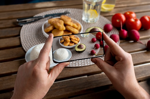 Close up on food lover taking pictures of meal