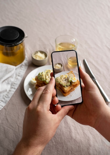 Free photo close up on food lover taking pictures of meal