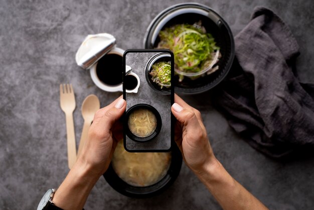 Close up on food lover taking pictures of meal