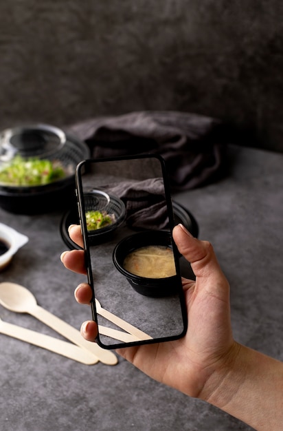 Free Photo close up on food lover taking pictures of meal