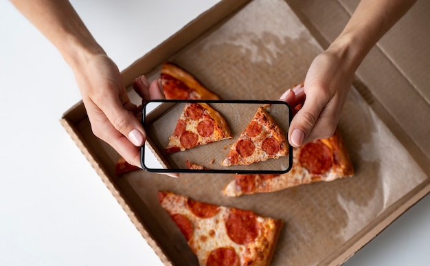 Free photo close up on food lover taking pictures of meal