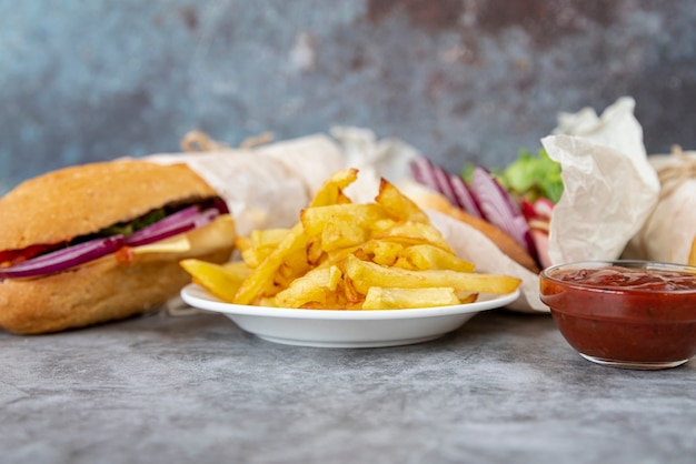 Close-up french fries with sandwich