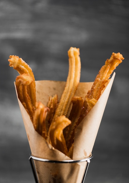 Close-up fried churros in a wrapping paper