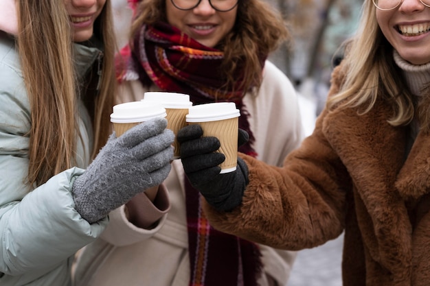 Close-up friends holding coffee cups