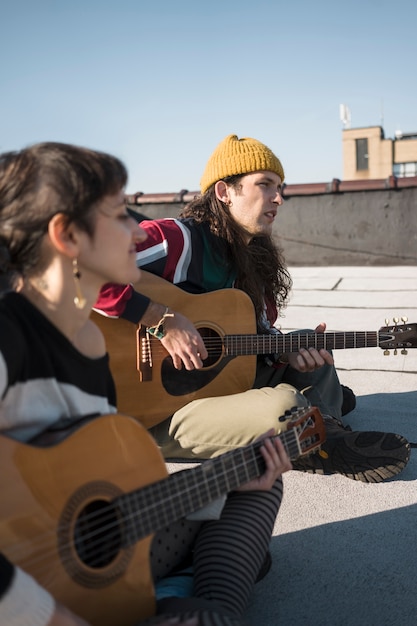 Close up friends making music together