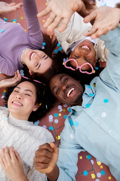 Close up friends sitting on floor