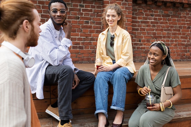 Free photo close up friends sitting outdoors