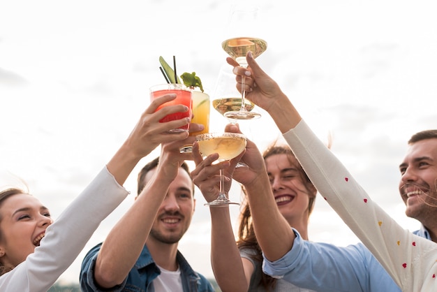 Close-up friends toasting at a party