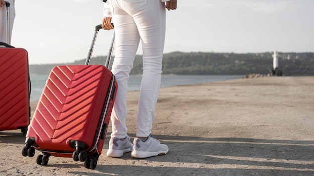 Close-up friends traveling with luggage