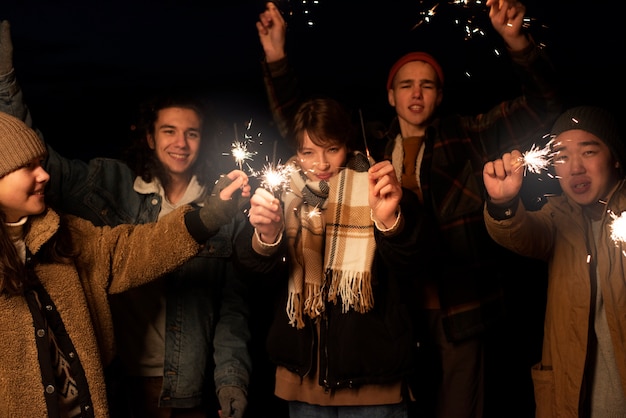 Free Photo close up friends with fireworks