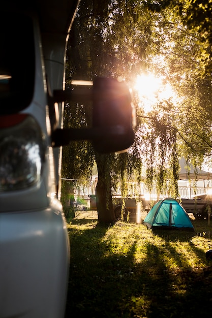 Close-up front van view with tent in background