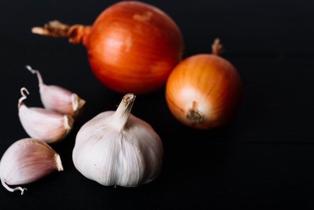 Free Photo close-up of garlic bulb and onions on black background