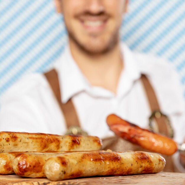 Close-up of german sausages on wood plate