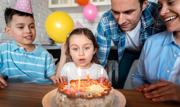 Close up girl blowing candles