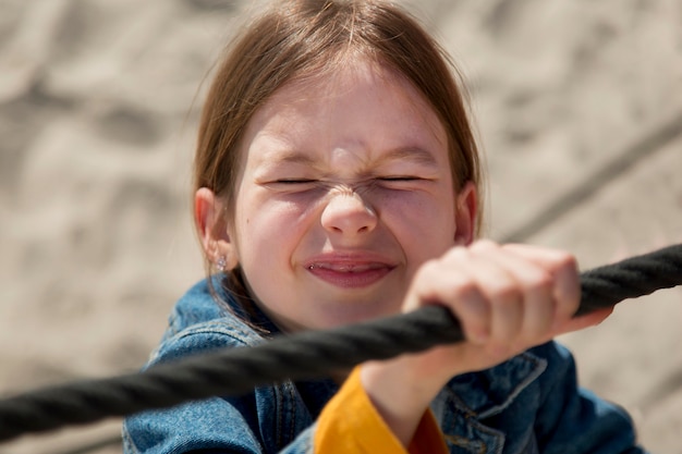 Free Photo close up  girl climbing rope