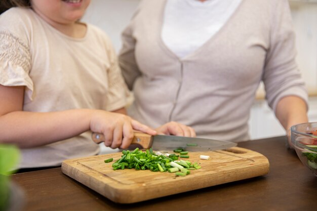 Close up girl cooking with grandma