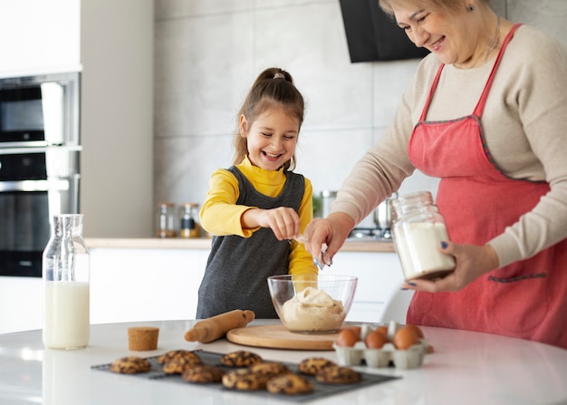 Close up on girl cooking with her grandmother