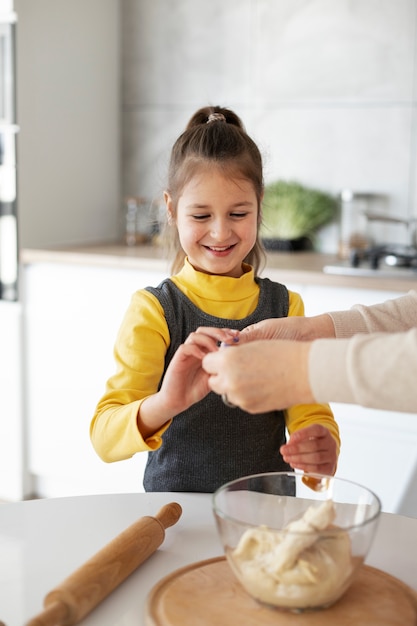 Close up on girl cooking with her grandmother