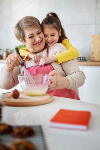 Close up on girl cooking with her grandmother