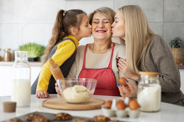 Close up on girl cooking with her mother and grandmother