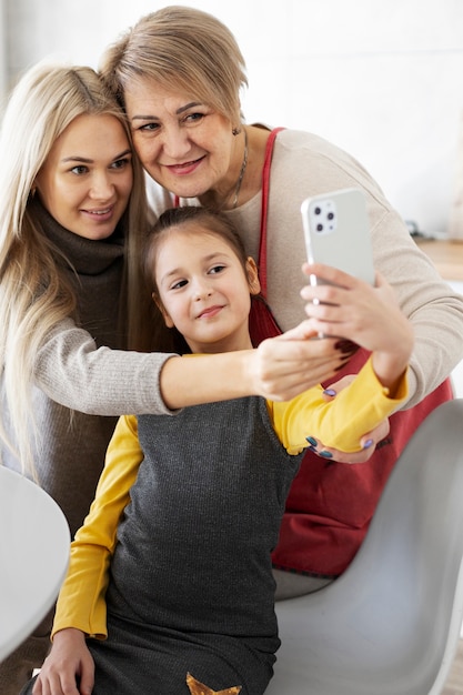 Close up on girl cooking with her mother and grandmother