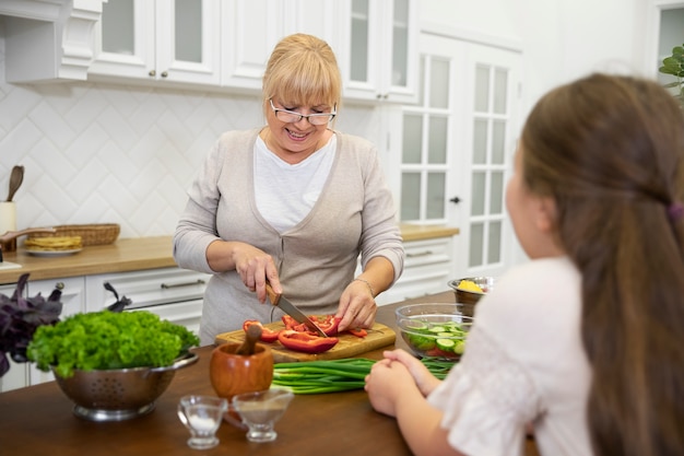 Free photo close up girl and grandma cooking together