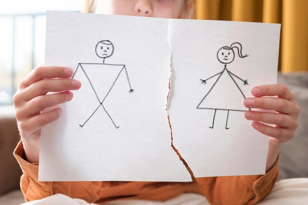 Free photo close-up girl holding broken drawing