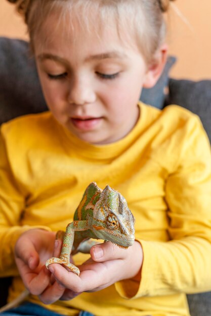 Close up girl holding chameleon