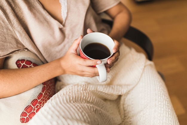 Close-up of girl holding coffee cup in hands