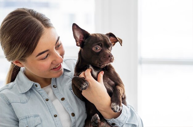 Close-up girl holding dog