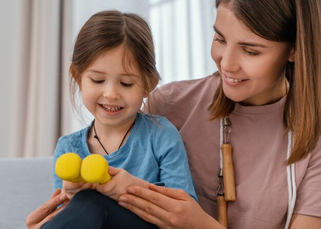 Close up girl holding dumbbells