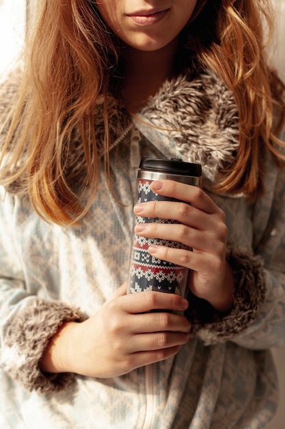 Free Photo close-up girl holding a flask