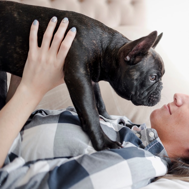 Close-up girl holding her little puppy