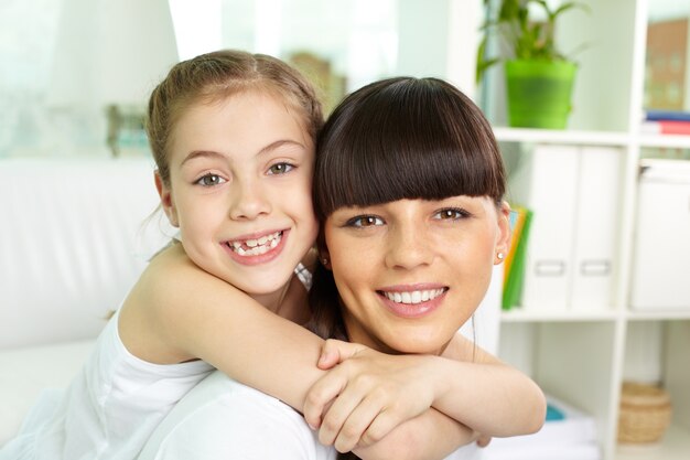 Close-up of girl hugging her mother