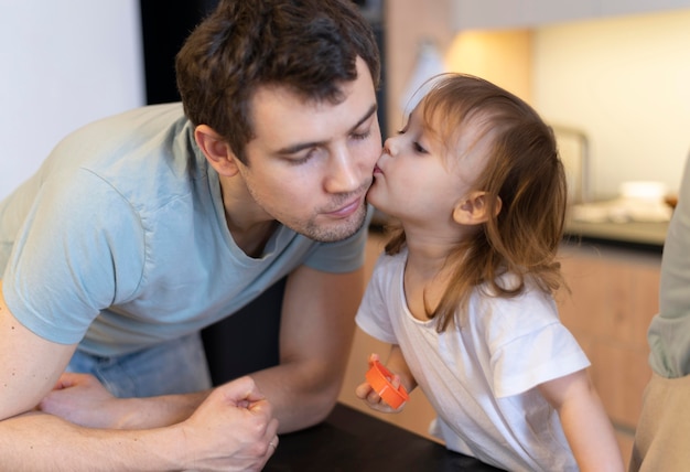 Close-up girl kissing father on cheek