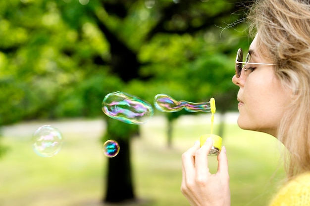 Close-up girl playing with bubble machine