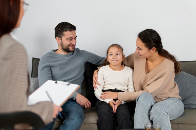 Close up girl at therapy session with parents